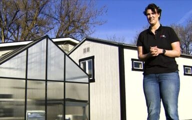 young man wearing a black t shirt while talking with his hans